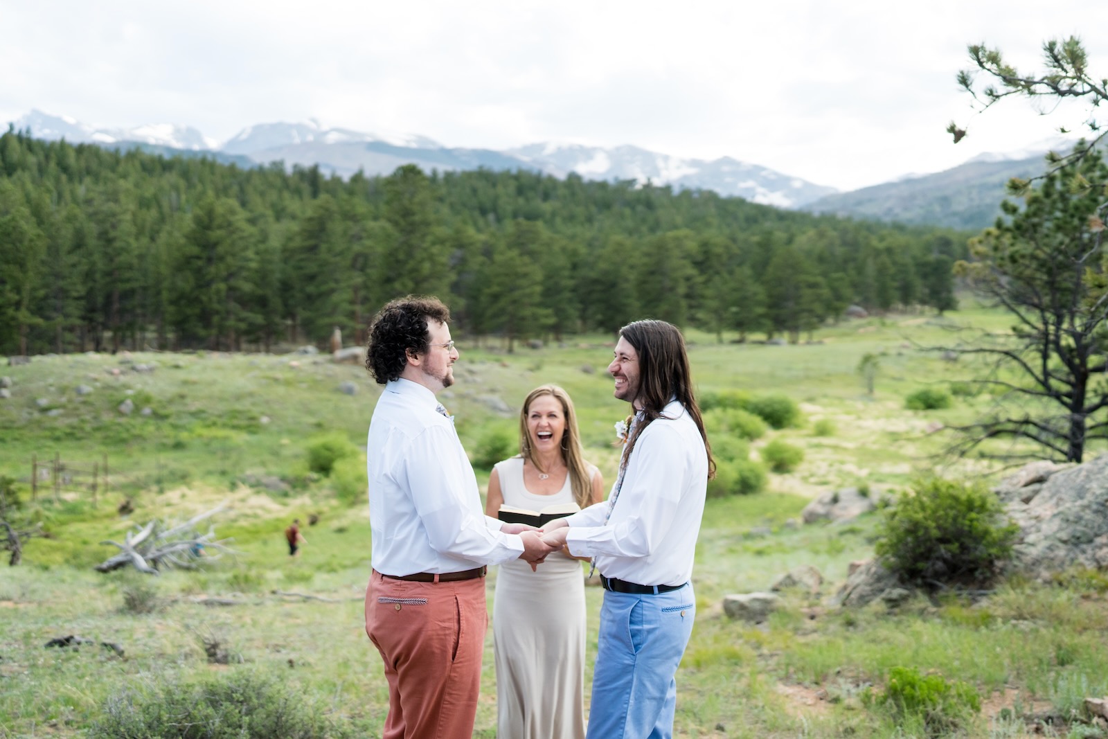 Wendee officiating an outdoor ceremony for a couple in a meadow